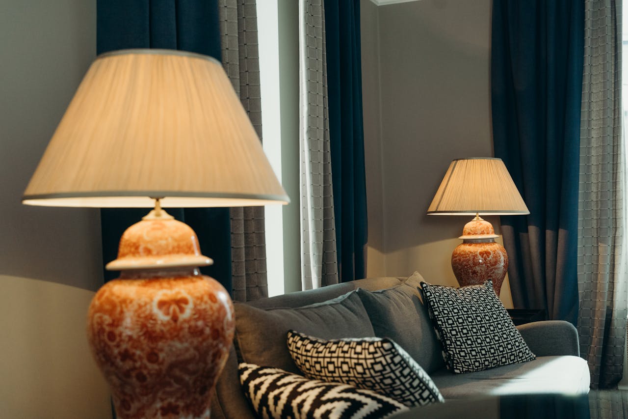 Luxurious living room featuring ceramic lamps, cozy sofa, and elegant decor for a warm ambiance.